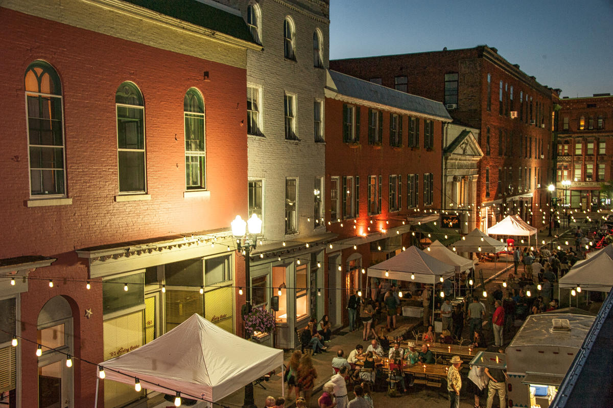 Downtown Geneva NY evening scene with string lights and restaurants
